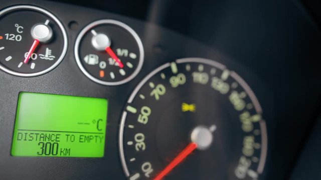 Close up image of a car's dashboard and the car computer showing information.