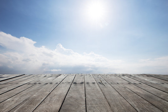 empty wood floor in blue sunny sky
