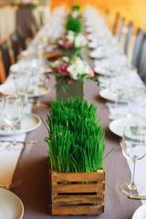 Served wedding table with grass decorations