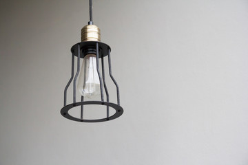 black ceiling light lamp and grey wall, vintage light bulb, free copy space for text