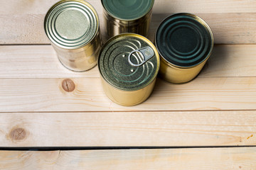 Tin cans for food on wooden background