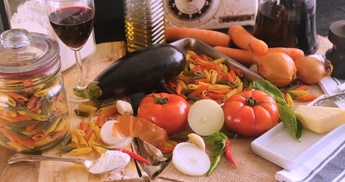Dolly view of  Italian pasta and ingredients for tomato sauce