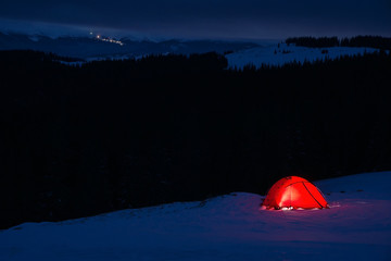 tent at night in winter mountains