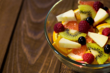 Delicious fruits salad in plate on table close-up