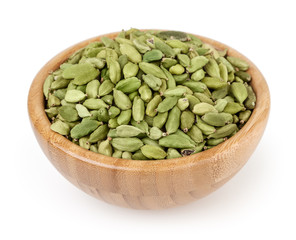 Cardamon in wooden bowl isolated on white background with clipping path