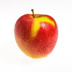 Apple with drops of dew on a white background.