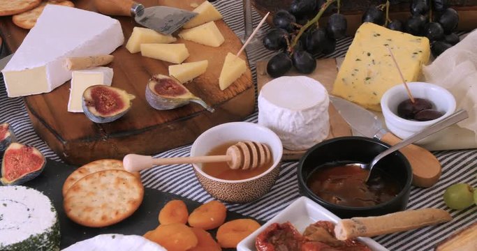 Dolly view of an assortment of French and British cheese