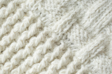 Knit texture of white wool knitted fabric with cable pattern as background