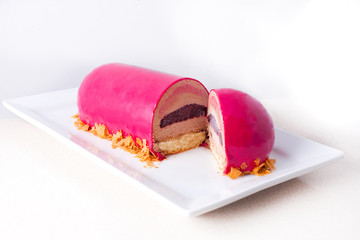 pink cake oval, cut in half, on a white background