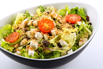 Lettuce salad tomato cheese and nuts