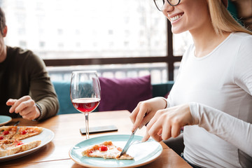 Cropped photo of young friends sitting in cafe