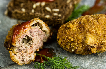 Homemade meat cutlets with parsley, ketchup and bread on white plate