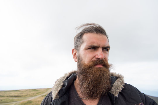 bearded handsome serious man on mountain top