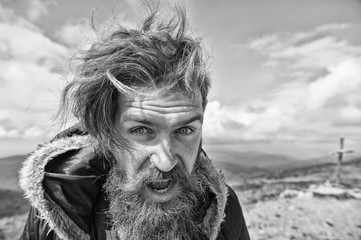 bearded man, brutal caucasian hipster with moustache on windy mountain