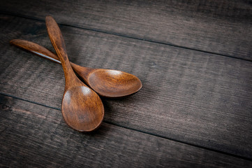 wooden spoons on table background, closeup, free space for your text