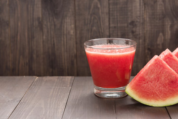 Healthy vegetable. Glass of red tomato juice on wooden table