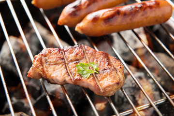 BBQ sausages and meat on the grill.