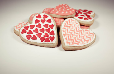 Heart shaped cookies with icing on a light background. Retro toning
          