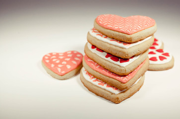 Heart shaped cookies with icing on a light background. Retro toning
          