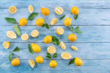 Ripe lemons on the blue wooden table.