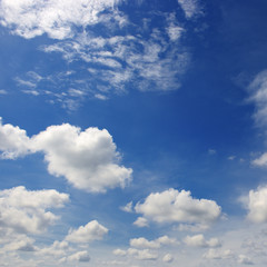Naklejka na ściany i meble Beautiful white clouds in the dark blue sky.