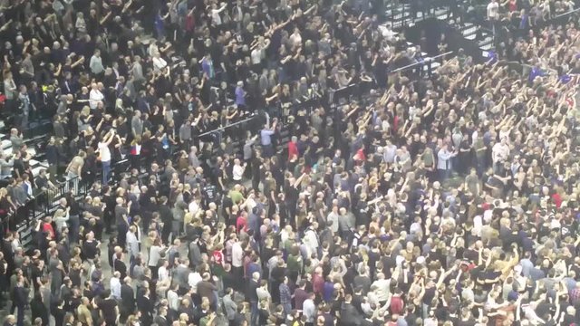Large Crowd of People At Rock/Metal Concert in big stadium doing synchronized movements