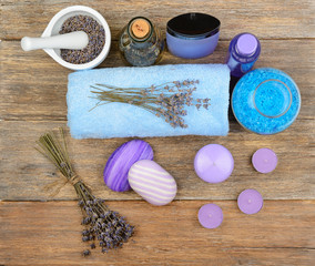 Fototapeta na wymiar Goods for spa: soap, sea salt, towel, oil of lavender on wooden table.