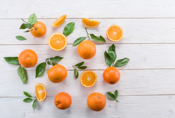 Ripe oranges on the white wooden table.