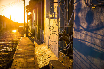 Cuban street with oldtimer at sunset in Trinidad, Cuba