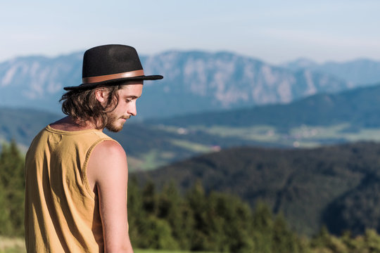 Austria, Mondsee, Mondseeberg, young man wearing a hat