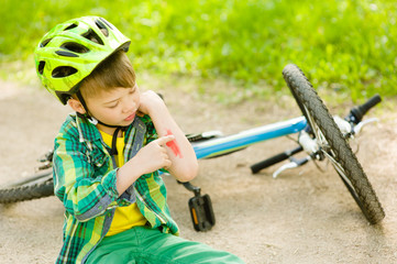 boy fell from the bike in a park