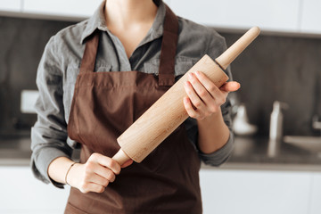 Cropped image of young woman standing in kitchen