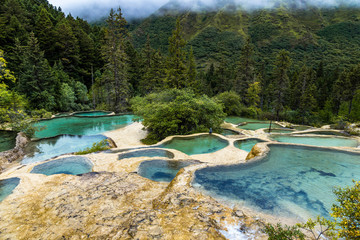 Huanglong National Park, Sichuan, China, famous for its colorful pools formed by calcite deposits....
