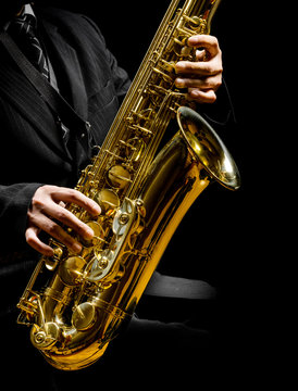 saxophone in male hands on a black background