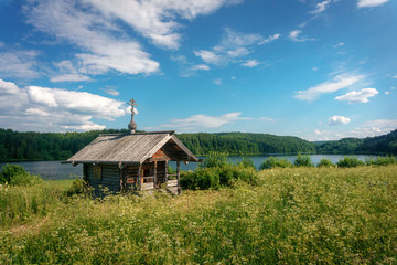 Fototapeta na wymiar Russian wooden chapel in the forest