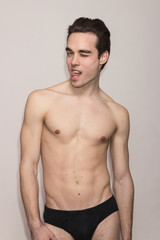 Fototapeta premium young man shirtless body slim fit winking, tongue out