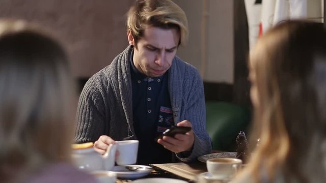 Young hipster browsing internet on smart phone