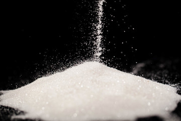 The sugar lies on the black background
