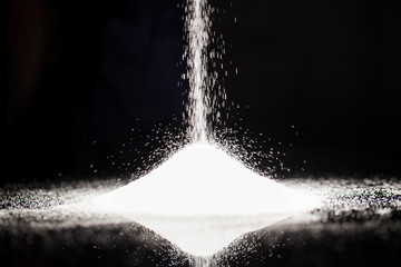 The sugar lies on the black background