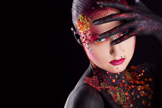 Young attractive girl in bright art-makeup, body painting. Profile