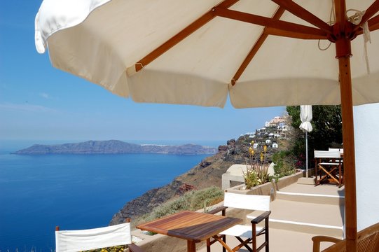 Piece of Mediterranean cruise On Santorini island, Greece. The view from the hotel balcony on the lower terrace and the shore of the Aegean sea. The system of the Cycladic Islands