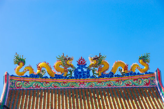 Chinese style dragon statue on blue sky background.