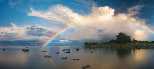 sea landscape at sunrise, boulders on the sea shore,rainbow