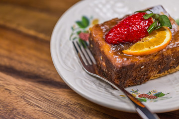 Strawberry-Lemon Cake on Saucer with fork on wooden table