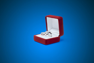 wedding rings and jewelry box on a wooden table