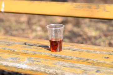 Plastic glass on park bench