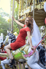 Bride with balloons rides on the carousel