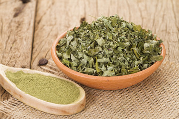 Dust and moringa leaves on wooden background
