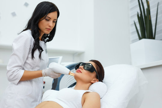 Beautician Using Laser For Skin Rejuvenation In Spa Salon