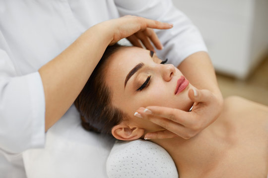 Woman Skin Care. Beautiful Female Model Receiving Face Massage